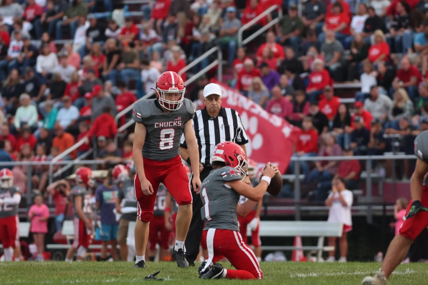 Chucks kicker preparing for a field goal with the crowd behind him